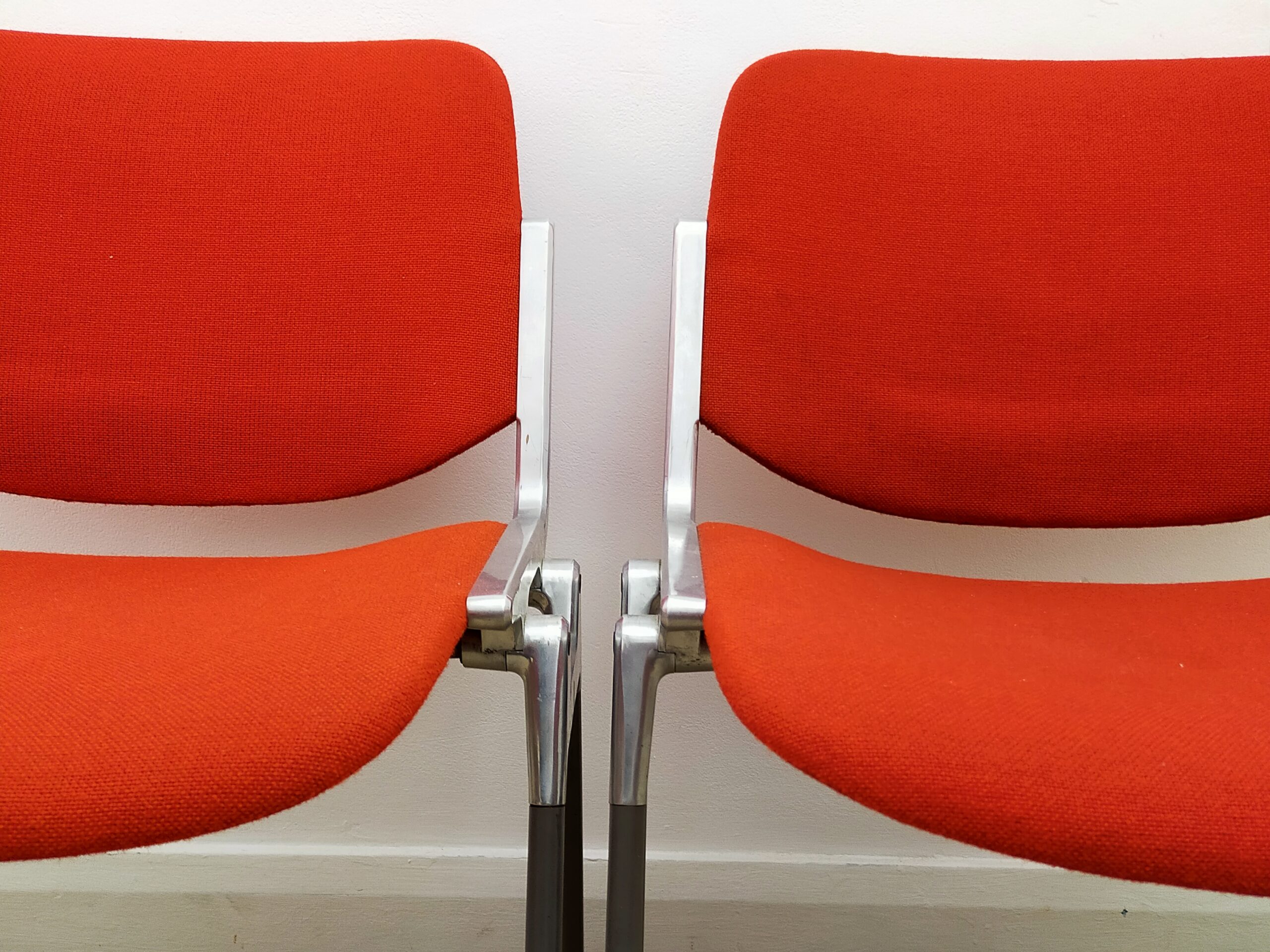A pair of red Italian designer retro desk chairs by Giancarlo Piretti - Castelli